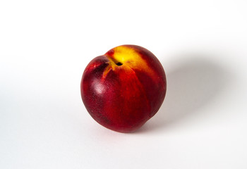 A peach on a white background