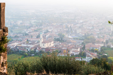 Sunset from the Cormons hill. Among fog, vineyards and fiery colors. Italy