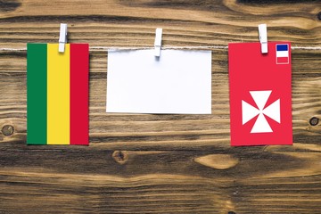 Hanging flags of Bolivia and Wallis And Futuna attached to rope with clothes pins with copy space...