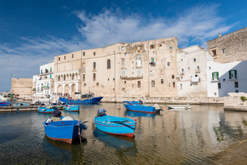 Obraz premium View of Monopoli harbor with colorful azure fishing boats, Apulia, Italy.