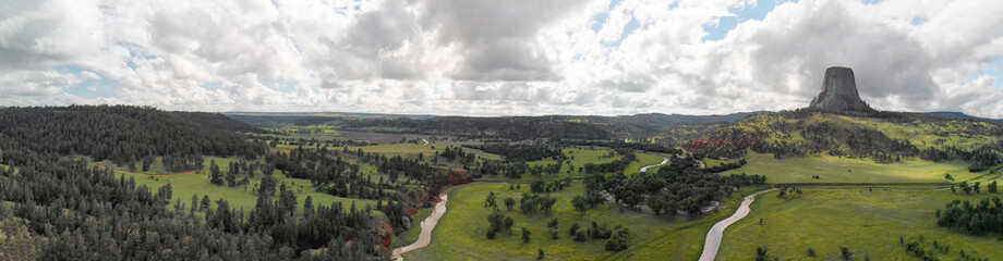 Obraz premium Panoramic aerial view of Devils Tower National Monument at summer sunset, Wyoming from drone perspective