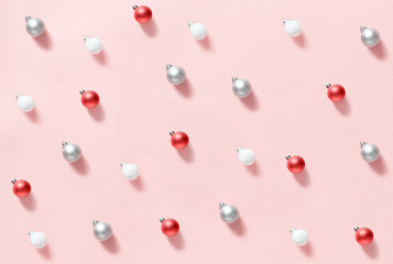 Christmas baubles on a light pink background