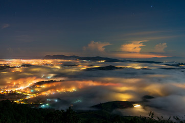 beautiful long exposure landscape of the fog city at midnight with dramatic streets light and...