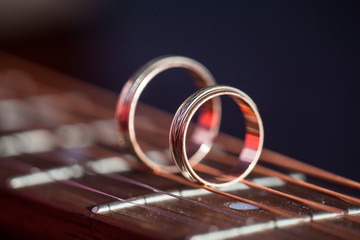 Two Wedding Rings on guitar strings. Shallow Depth Of Field