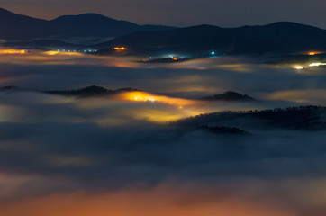 beautiful long exposure landscape of the fog city at midnight with dramatic streets light and...