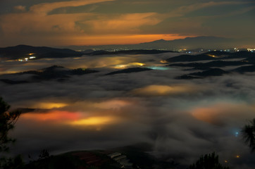 beautiful long exposure landscape of the fog city at midnight with dramatic streets light and...