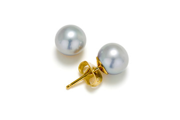 Grey pearl stud earrings in gold on a white background.