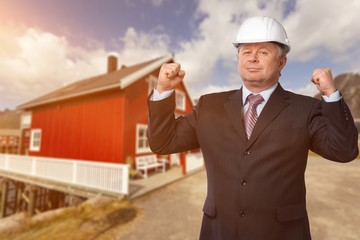 Engineer taking a note. Focused man in white hardhat holding a clipboard and writing. Waist up studio shot isolated on white.