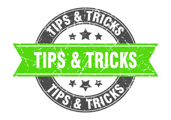 Fototapeta premium tips & tricks round stamp with green ribbon. tips & tricks