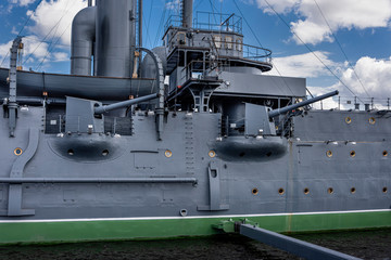 Russia, Saint Petersburg: Side view of famous historic cruiser ship Aurora  on Neva river in the city center of the Russian towns with canon and blue sky - concept history revolution. © Rolf G. Wackenberg