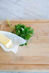 Parsley and butter on cutting board