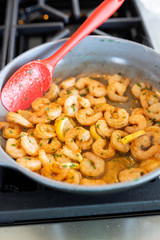 Sautéing shrimp in butter and seasoning