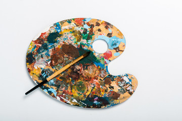 top view of palette with colorful gouache paint isolated on white