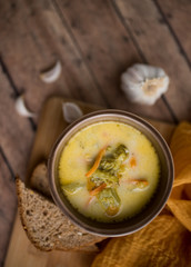 broccoli cheese soup served with toasted bread in a bowl