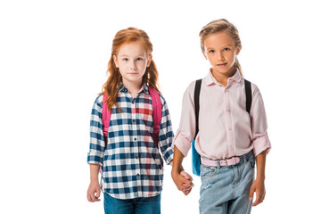 Fototapeta premium cute schoolkids with backpack holding hands isolated on white