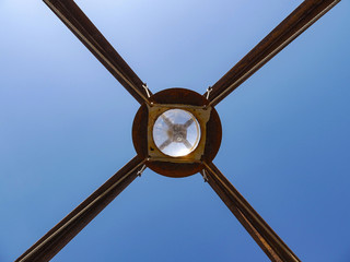 A large glass sphere at the top of a metal pyramid. Space installation.