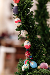 Easter background - colorful ester eggs hanging on fir tree. Easter eggs on Christmas tree