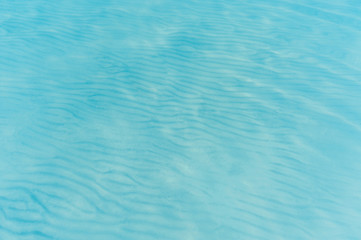 Background transparent sea water and sand bottom