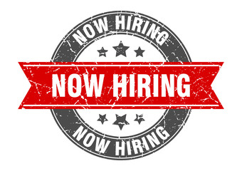 now hiring round stamp with red ribbon. now hiring