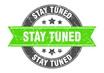 stay tuned round stamp with green ribbon. stay tuned