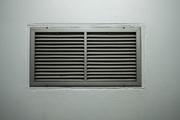 A grating of ventilation installed on the cement wall