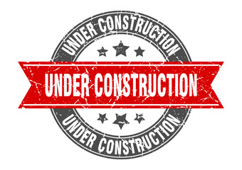 under construction round stamp with red ribbon. under construction
