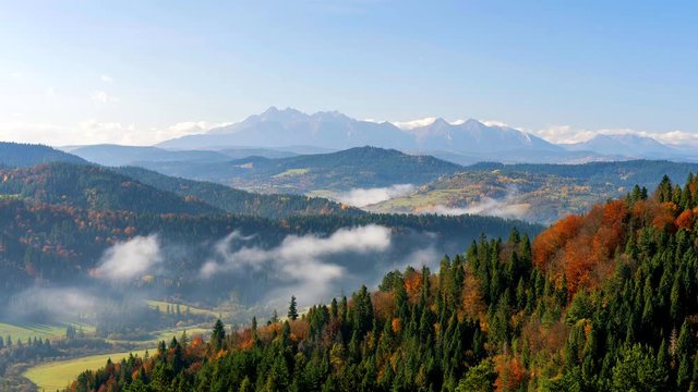 Time lapse footage of beautiful autumn landscape with High Tatras Mountains in background, Slovakia.