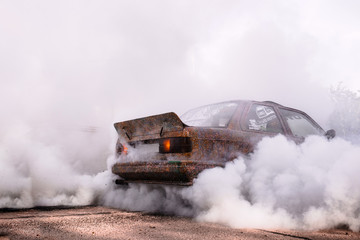 Moldova 25.09.2019. Sport modern Stance Car racing car drifting with smoke drift burnout, big colourful green blue clouds with clean wheels and burning tires . Extreme street stunts. © Andrian