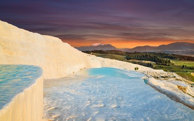 Sunset view of amazing Pamukkale. Travertine terrace formations with flowing thermal springs in Pamukkale most visited attraction in Turkey.