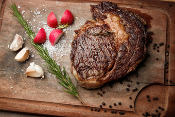 steak from beef, steak with vegetables, proper nutrition, healthy food,  a piece of boiled pork on a wooden board, presentation and serving, rustic style, vegetables for meat, 