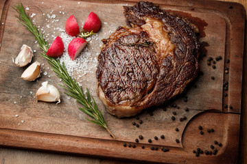 steak from beef, steak with vegetables, proper nutrition, healthy food,  a piece of boiled pork on a wooden board, presentation and serving, rustic style, vegetables for meat, 