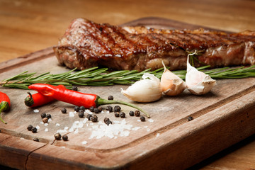 steak from beef, steak with vegetables, proper nutrition, healthy food,  a piece of boiled pork on a wooden board, presentation and serving, rustic style, vegetables for meat, 