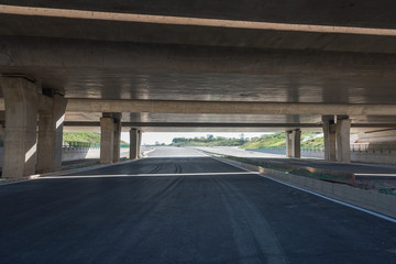 Perspective view of pier and asphalt pavement under concrete structure overpass