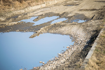 old dirty road with mud and water