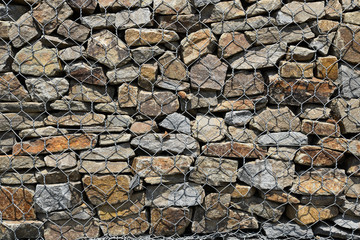 Gabion Wall From Rocks And Stones In Metal Wire Box. Reinforcement and Abutment Protective Construction.
