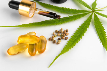 cannabis essential oil container with cannabis leaves and cannabis seeds