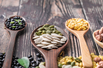 Mix of nuts in wooden spoon.