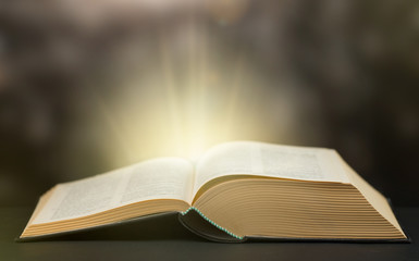 Old Book With Magic Lights On dark bokeh background