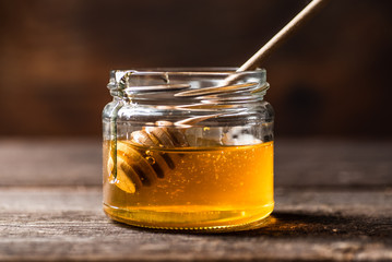 Jar of honey with honey dipper