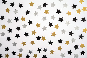 Silver, gold and black stars on a white background. Christmas decoration. Winter holidays concept. Christmas card.