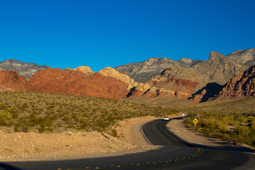 A car travels Scenic Loop Drive in Red Rock Canyon National Conservation Area in Nevada