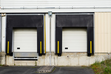Obraz na płótnie Canvas two loading docks Bay Doors at Distribution for trucks at warehouse