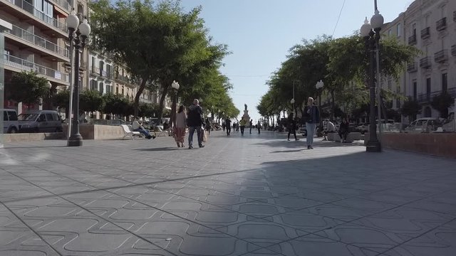 TARRAGONA, SPAIN-OCTOBER 24, 2019: Timelapse of people walking on the Rambla Nova Street in Tarragona, Spain. The Rambla Nova is over 150 years old.