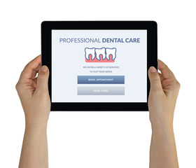 Hands holding tablet with dental care concept on screen