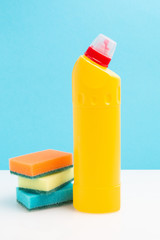 Cleaning sponges and yellow bottle with cleaning agent