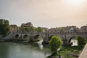 Bridge over the Tiber river in Rome at sunset