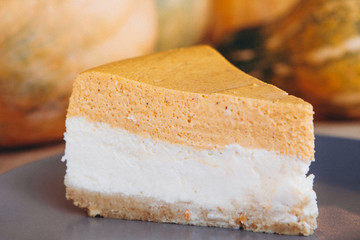 Piece of pumpkin homemade cake. Festive dessert concept. pumpkin tart on cozy cafe background, selective focus, noise effect