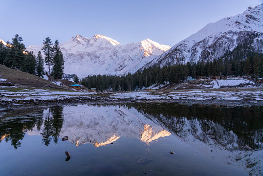 Water reflection of Nanga parbat mountain range at Fairy meadows during the sunset period , gilgit-baltistan