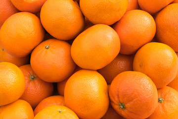 Oranges and tangerines lie on the window of a market, store, supermarket