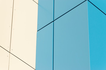 Geometric color elements of the building facade with planes, lines, corners with highlights and reflections for the abstract background and texture of blue, turquoise, white colors. Place for text